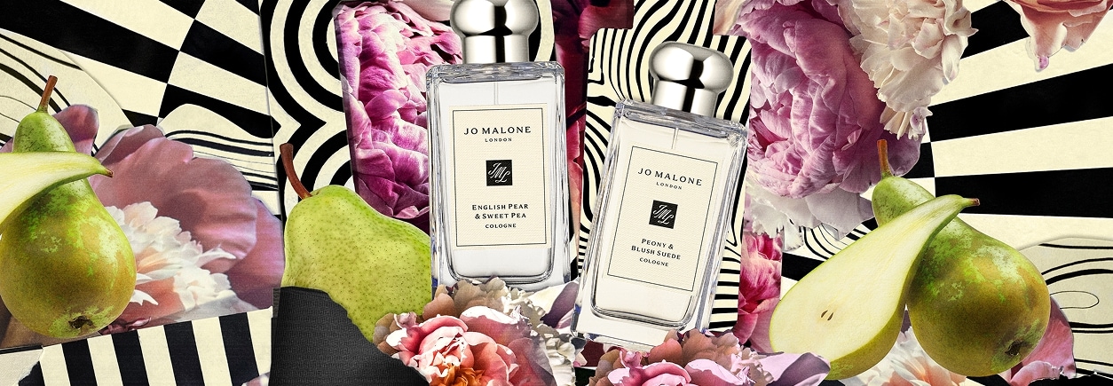 Jo Malone London bottles surrounded by pink flowers and fruit over black-and-white swirls.
